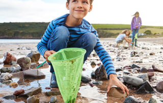 Child with net on seashore