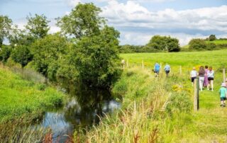 People walking by river